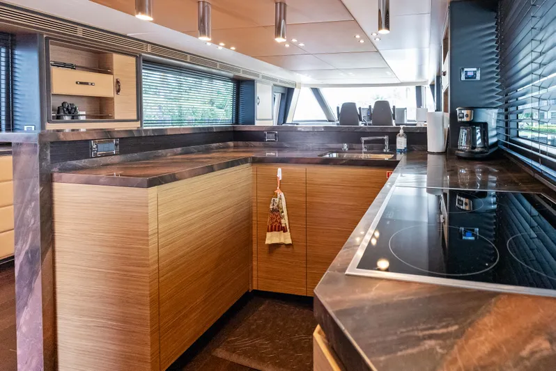  Yacht Photos Pics Luxurious kitchen interior of 2016 Azimut Magellano 76 yacht with modern appliances.