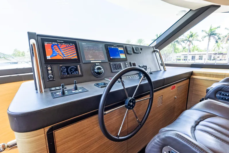  Yacht Photos Pics Helm of 2016 Azimut Magellano 76 yacht with navigation screens and leather seating.