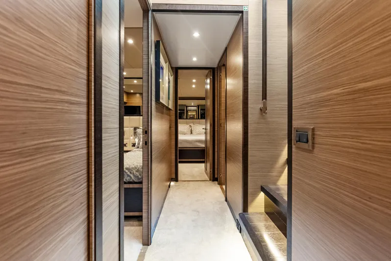  Yacht Photos Pics Luxurious interior hallway of 2016 Azimut Magellano 76 yacht with modern wood paneling.