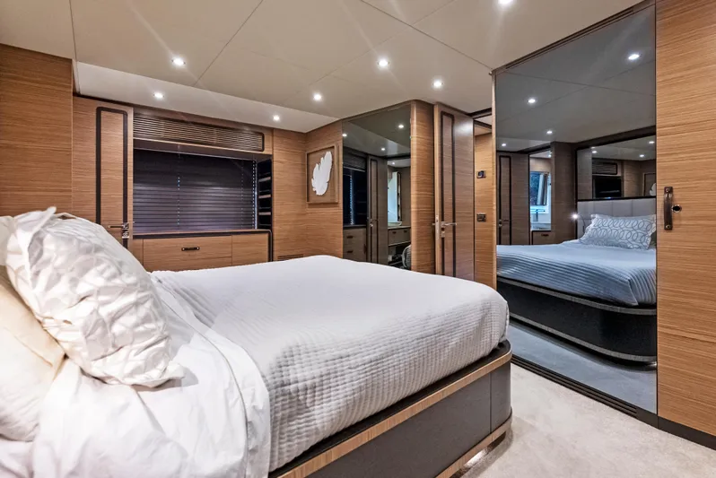  Yacht Photos Pics Luxurious bedroom interior of 2016 Azimut Magellano 76 yacht with modern wood finishes.