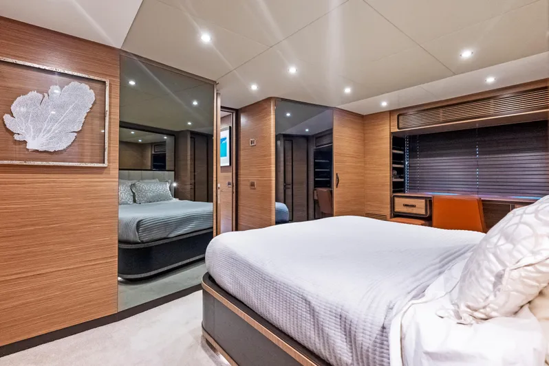  Yacht Photos Pics Luxurious bedroom interior of 2016 Azimut Magellano 76 yacht with modern decor and ambient lighting.