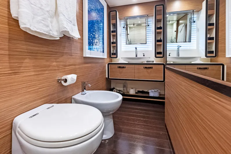  Yacht Photos Pics Luxurious bathroom in 2016 Azimut Magellano 76 yacht with wood paneling and dual sinks.