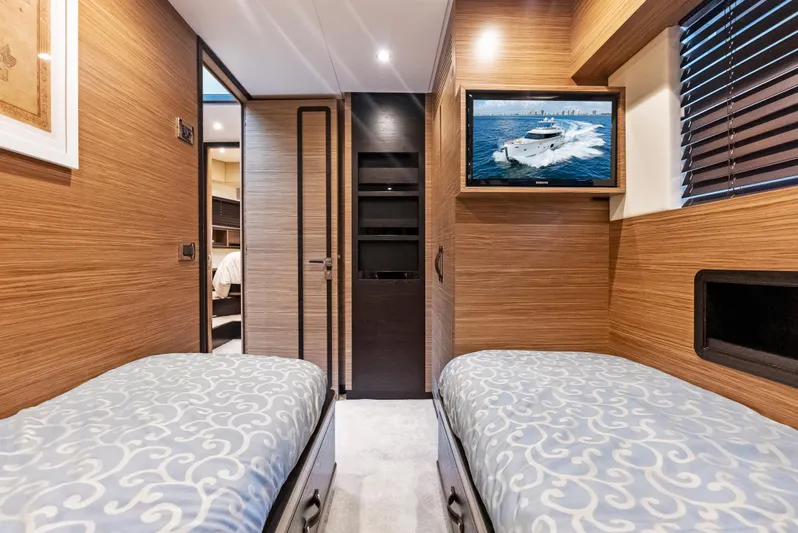  Yacht Photos Pics Interior of 2016 Azimut Magellano 76 yacht with twin beds and wall-mounted TV.
