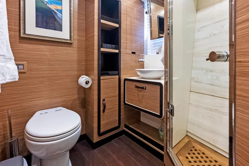  Yacht Photos Pics Luxurious bathroom in 2016 Azimut Magellano 76 yacht with modern fixtures and wooden accents.