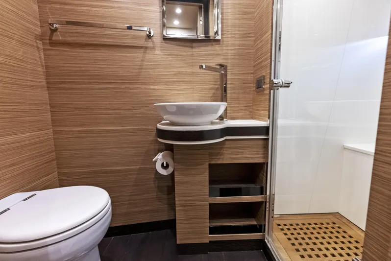  Yacht Photos Pics Bathroom interior of 2016 Azimut Magellano 76 yacht with modern fixtures and wooden accents.