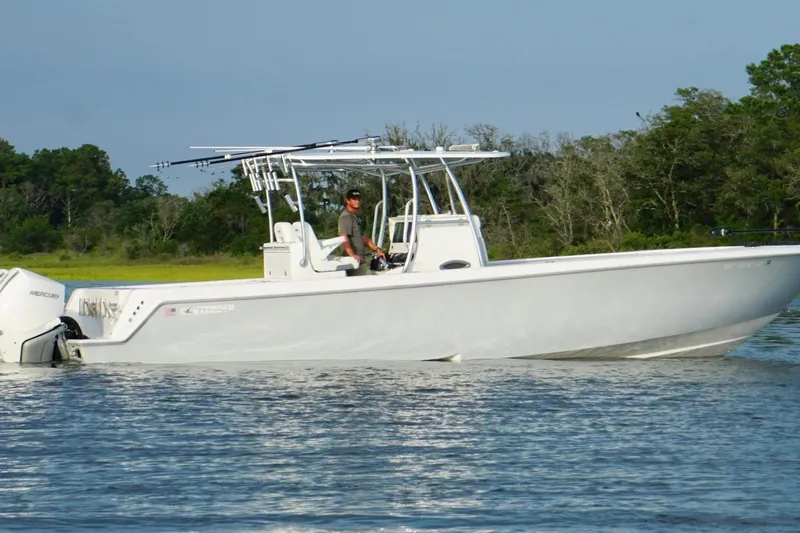  Yacht Photos Pics 2022 Contender 35 ST boat on water, with Mercury engines, near lush green shoreline.
