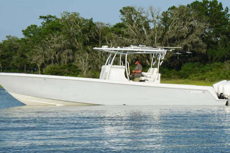  Yacht Photos Pics 2022 Contender 35 ST boat on water, with trees in the background.