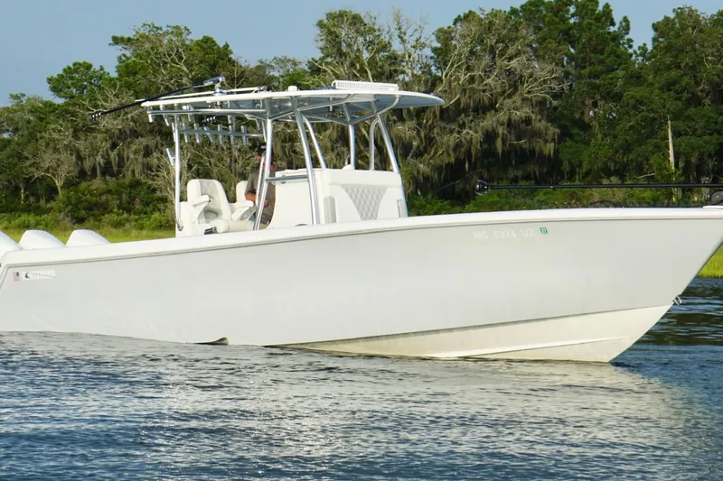  Yacht Photos Pics 2022 Contender 35 ST boat on calm water with lush green background.
