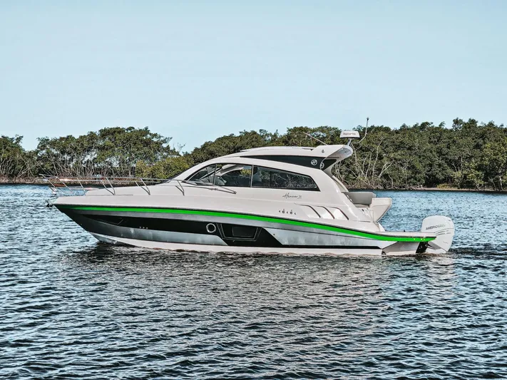 Custom Order Yours Today! Yacht Photos Pics 2025 Hanover 375 Outboard boat cruising on a calm lake with lush greenery.