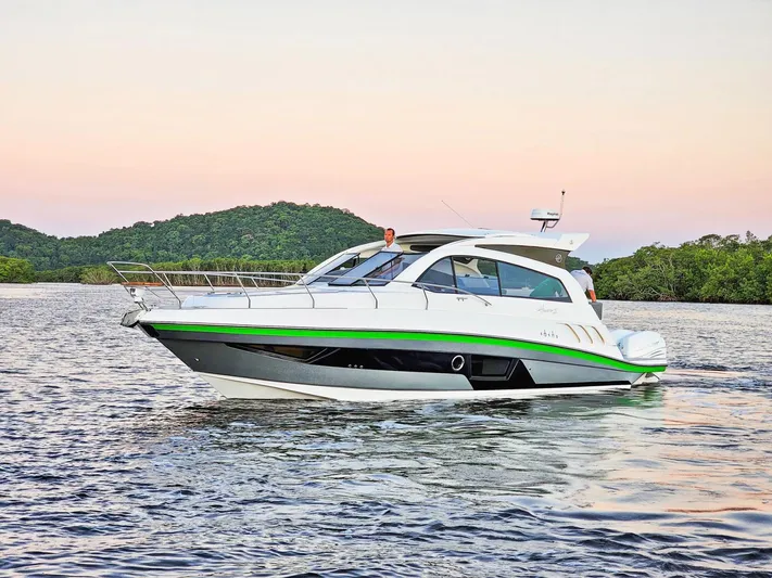 Custom Order Yours Today! Yacht Photos Pics 2025 Hanover 375 Outboard boat cruising on a serene lake at sunset.