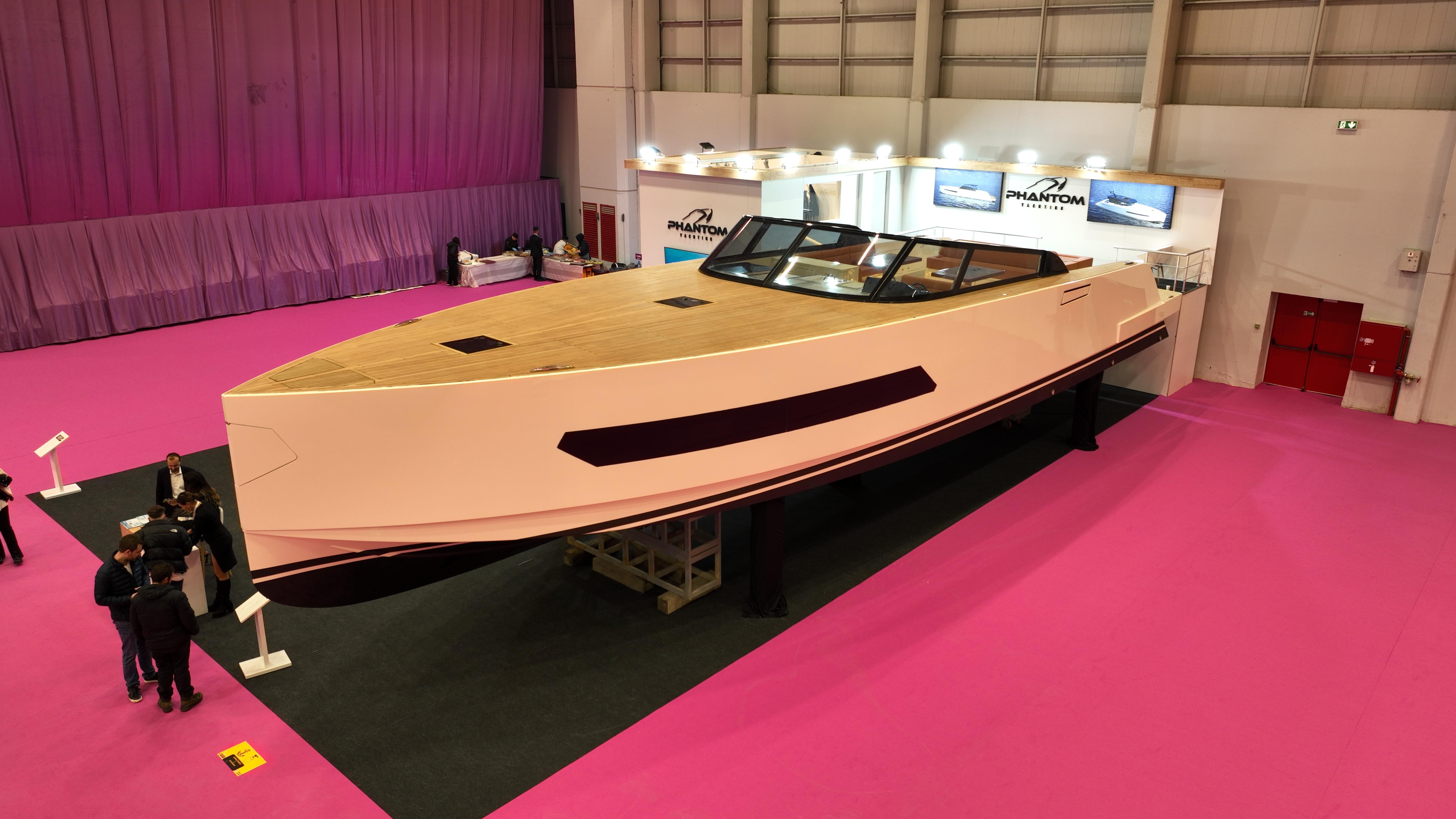 2026 Phantom Spook 62 luxury yacht displayed indoors on vibrant pink flooring.