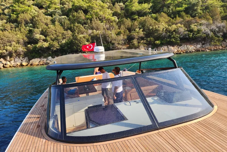  Yacht Photos Pics Luxurious Phantom Spook 62 yacht cruising near lush coastline, 2025 model.