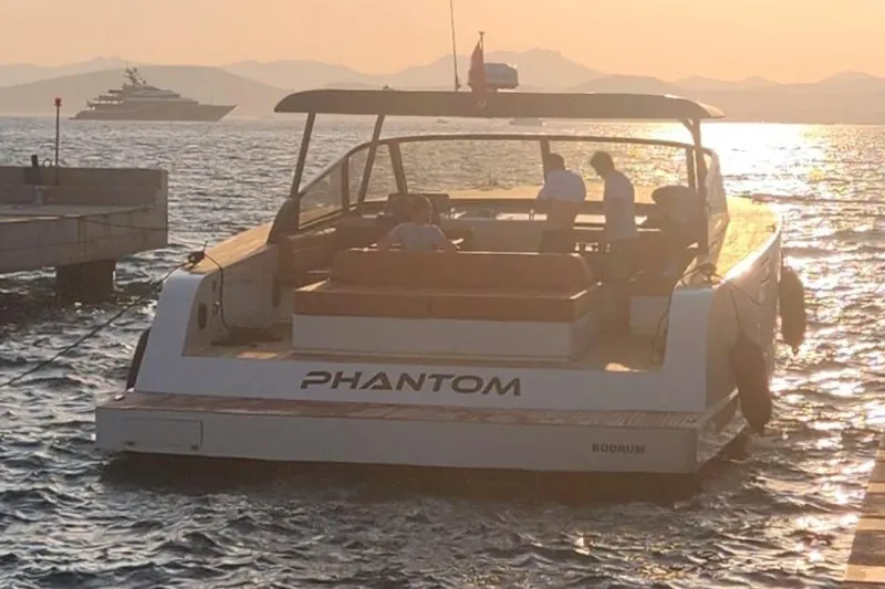  Yacht Photos Pics Luxury Phantom Spook 62 yacht at sunset, 2025 model, docked with passengers onboard.