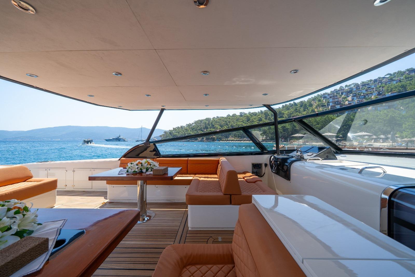 Luxurious 2025 Phantom Spook 62 yacht interior with elegant seating and scenic ocean view.