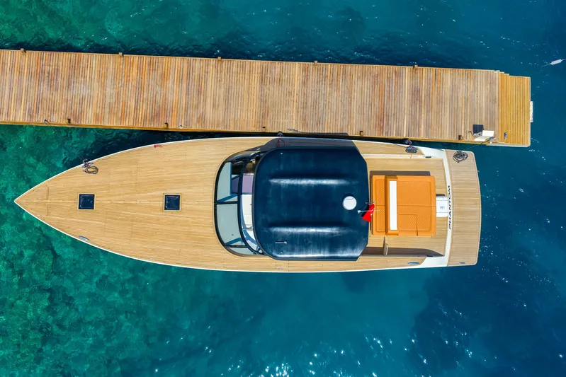  Yacht Photos Pics Aerial view of 2025 Phantom Spook 62 yacht docked on clear blue water.