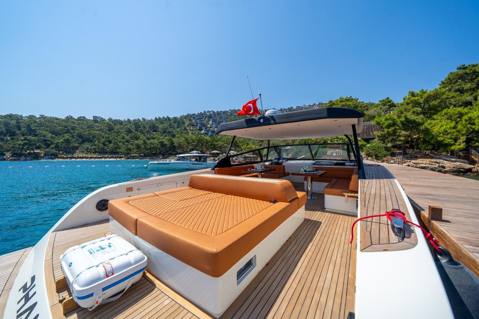 Luxurious 2025 Phantom Spook 62 yacht with spacious deck and scenic coastal view.