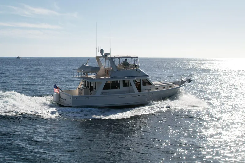 Treasure Yacht Photos Pics 1997 Offshore Yachts 48 Sedan cruising on open water under clear skies.