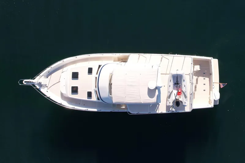 Treasure Yacht Photos Pics Aerial view of 1997 Offshore Yachts 48 Sedan on calm water.