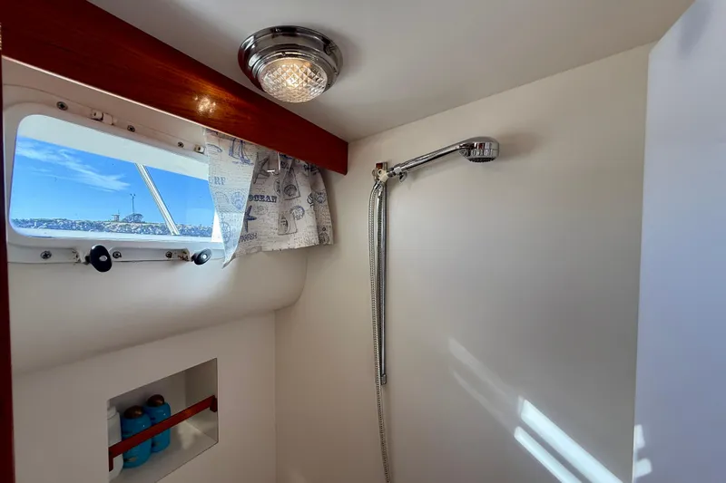 Treasure Yacht Photos Pics Shower area in 1997 Offshore Yachts 48 Sedan with window and curtain.