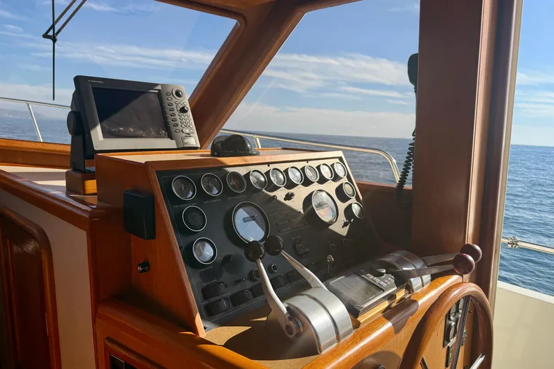 Treasure Yacht Photos Pics Helm of 1997 Offshore Yachts 48 Sedan with navigation equipment, overlooking the ocean.