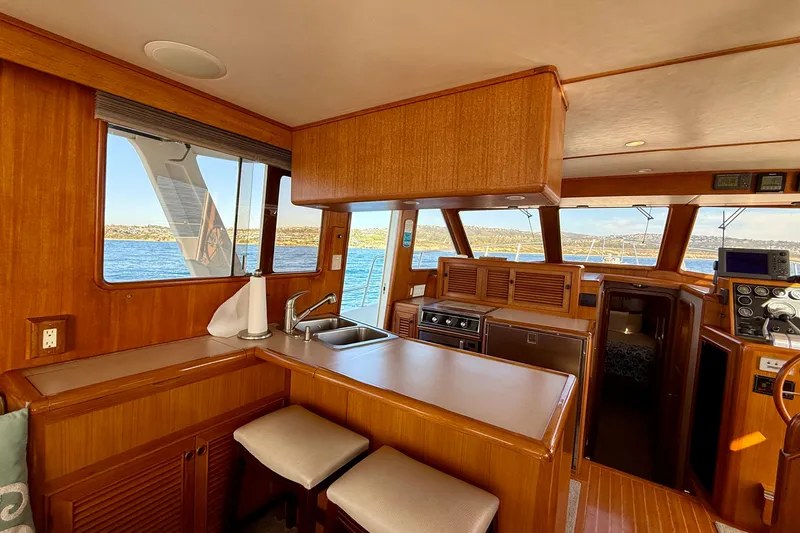Treasure Yacht Photos Pics Interior of 1997 Offshore Yachts 48 Sedan, featuring a wooden kitchen and ocean view.