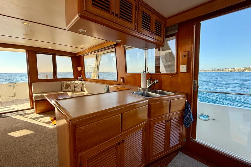 Treasure Yacht Photos Pics Interior of 1997 Offshore Yachts 48 Sedan with ocean view and wooden cabinetry.