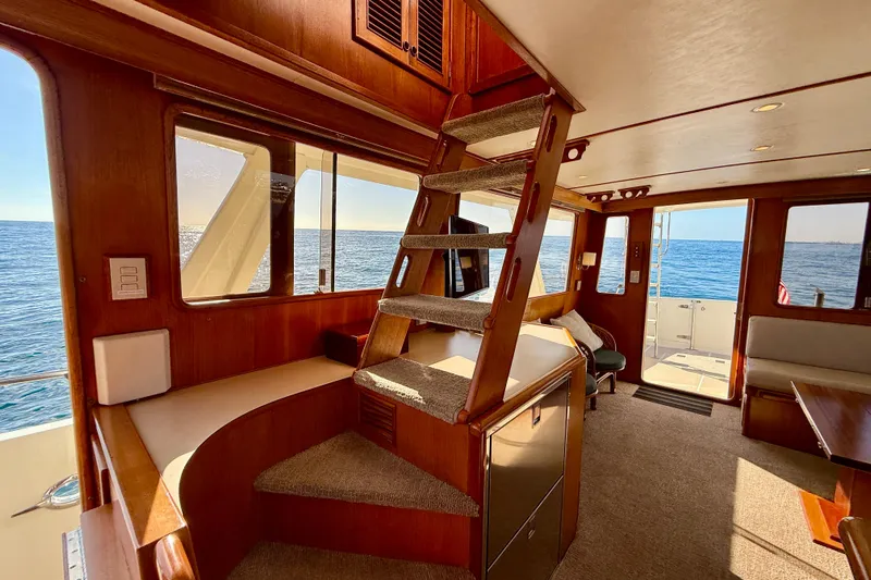Treasure Yacht Photos Pics Interior of 1997 Offshore Yachts 48 Sedan with ocean view and wooden finishes.
