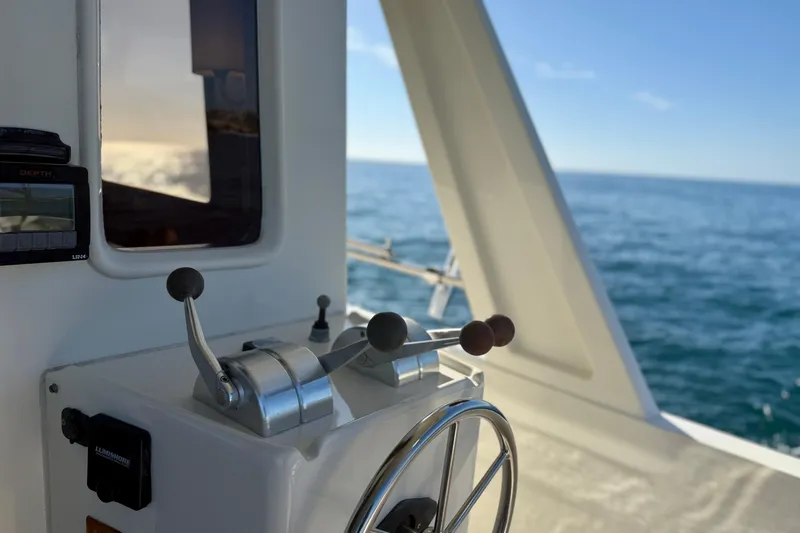 Treasure Yacht Photos Pics 1997 Offshore Yachts 48 Sedan helm with ocean view and control levers.