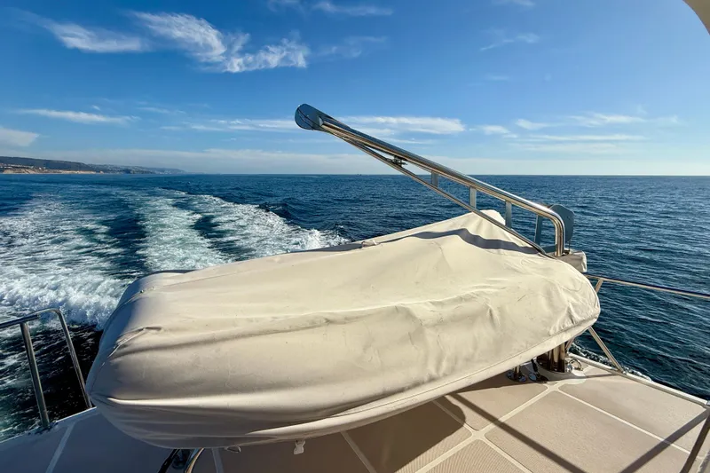 Treasure Yacht Photos Pics Offshore Yachts 48 Sedan 1997 cruising on open sea under clear blue sky.
