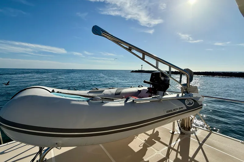 Treasure Yacht Photos Pics Inflatable boat on 1997 Offshore Yachts 48 Sedan, ocean view, sunny day.