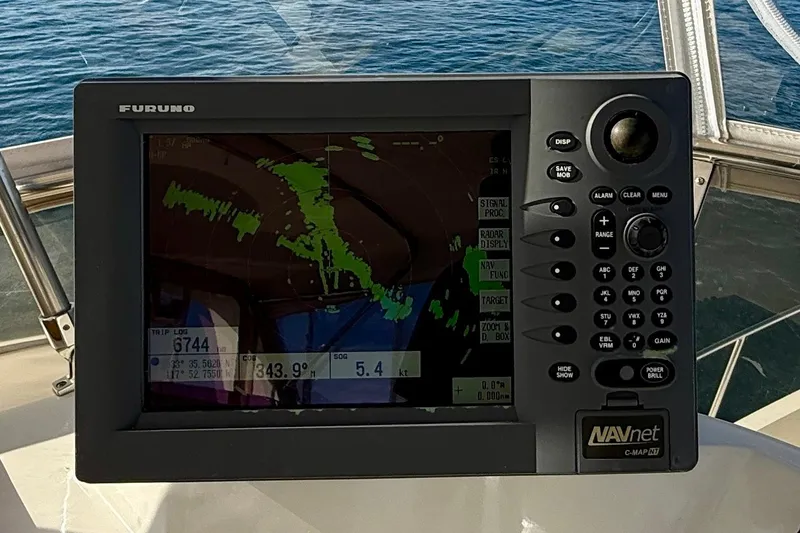 Treasure Yacht Photos Pics Navigation system on 1997 Offshore Yachts 48 Sedan, displaying radar and coordinates.