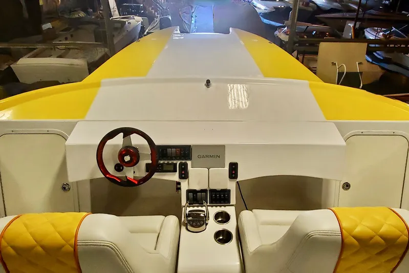  Yacht Photos Pics Interior view of 2005 Thriller Powerboats Super Cat 55 with yellow accents and Garmin controls.