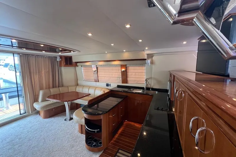 Our Trade Yacht Photos Pics Luxurious interior of 2006 Carver 56 Voyager yacht with elegant seating and modern kitchen.