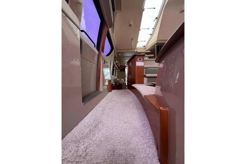 Our Trade Yacht Photos Pics Interior of 2006 Carver 56 Voyager yacht, featuring carpeted flooring and elegant wood finishes.