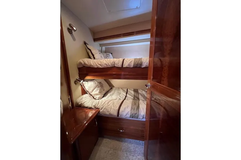 Our Trade Yacht Photos Pics Interior of 2006 Carver 56 Voyager with cozy bunk beds and wooden finish.