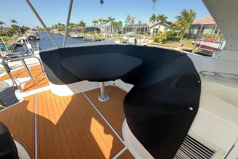 Our Trade Yacht Photos Pics 2006 Carver 56 Voyager yacht deck with seating area and waterfront view.