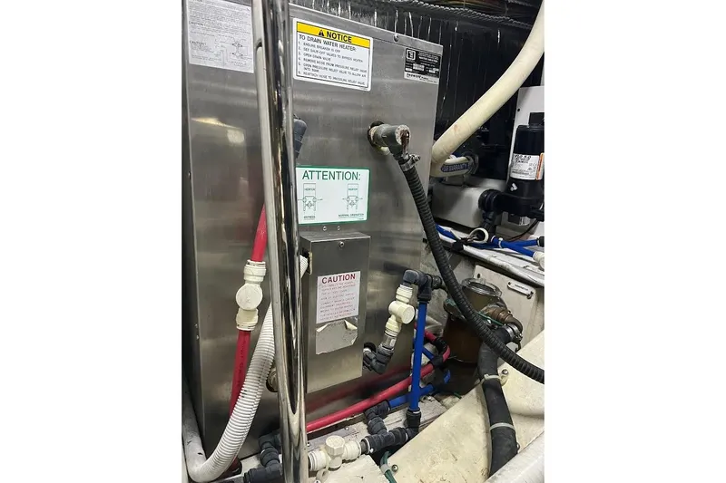 Our Trade Yacht Photos Pics Engine room of 2006 Carver 56 Voyager with water heater and plumbing components.