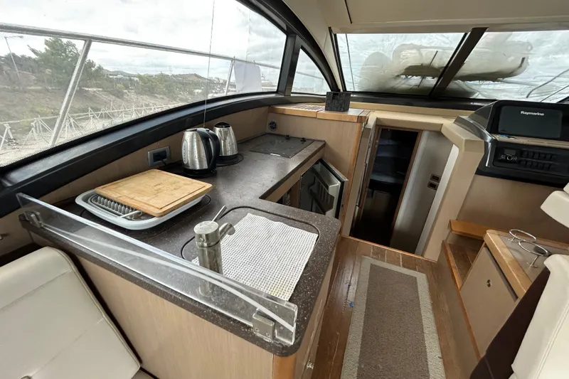  Yacht Photos Pics Interior of 2016 Sea Ray 400 Sundancer yacht with kitchenette and navigation area.