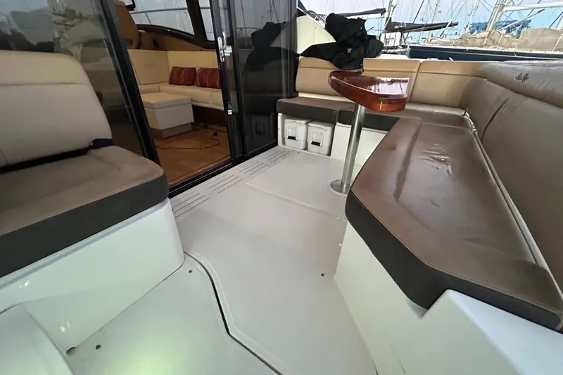  Yacht Photos Pics Interior view of 2016 Sea Ray 400 Sundancer yacht with beige seating and wooden table.