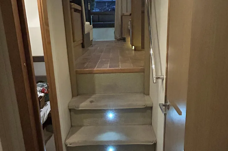  Yacht Photos Pics Interior stairs of 2016 Sea Ray 400 Sundancer yacht with carpet and handrail.