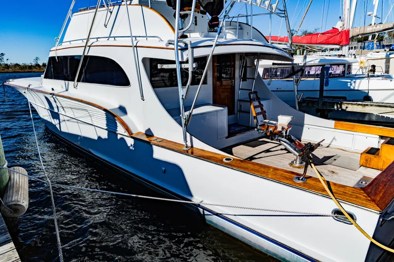 Lb. Cake Yacht Photos Pics 1987 Buddy Davis 61 Convertible yacht docked, showcasing sleek design and spacious deck.