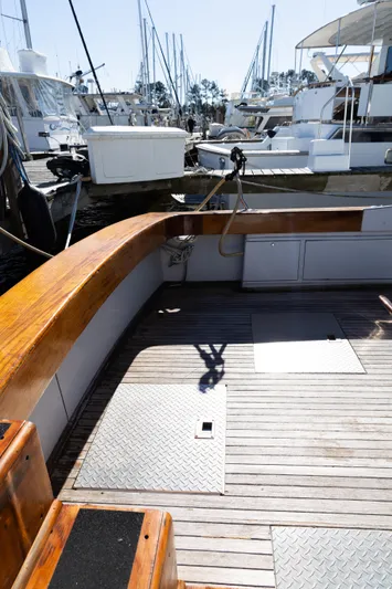 Lb. Cake Yacht Photos Pics 1987 Buddy Davis 61 Convertible yacht deck with wooden finish, docked at a marina.