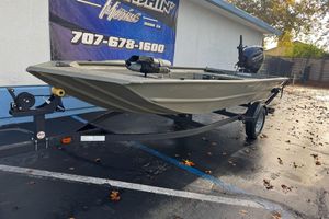 2026 Tracker Grizzly 1654 T Sportsman boat on trailer, parked outdoors.