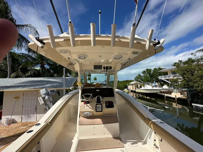  Yacht Photos Pics 2018 Scout 300 LXF boat interior with fishing rod holders and steering console.