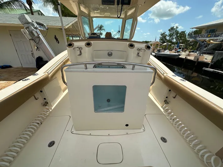  Yacht Photos Pics 2018 Scout 300 LXF boat interior with helm station and storage compartment.