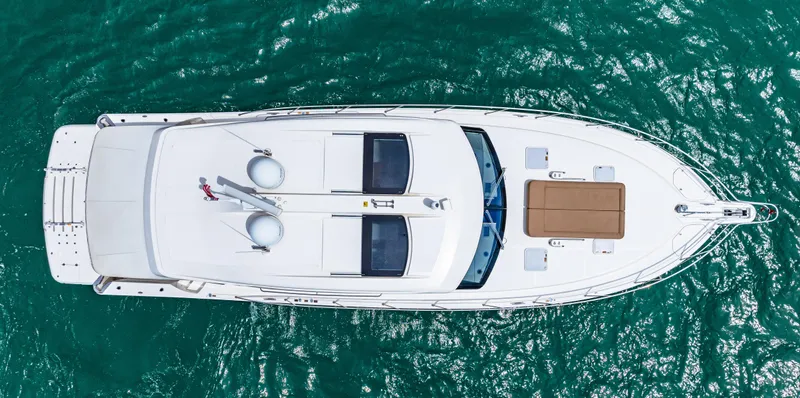 Boa Vida Yacht Photos Pics Aerial view of a 2017 Riviera 575 SUV yacht on the water.