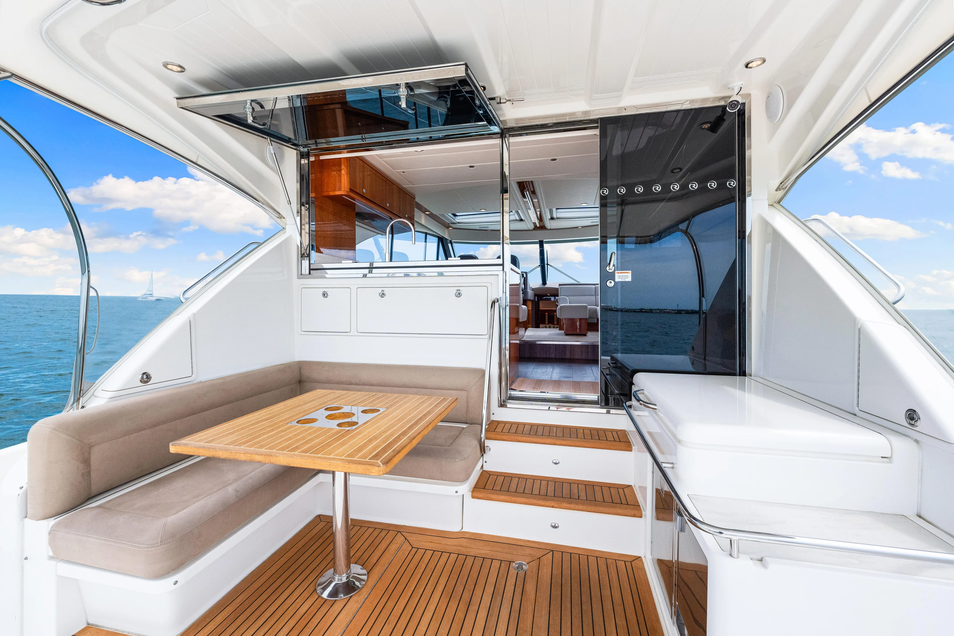 Boa Vida Yacht Photos Pics 2017 Riviera 575 SUV yacht interior with seating area and ocean view.
