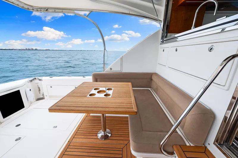 Boa Vida Yacht Photos Pics 2017 Riviera 575 SUV yacht deck with seating and ocean view.
