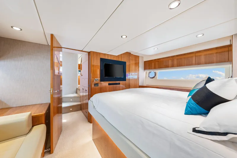 Boa Vida Yacht Photos Pics Luxurious bedroom interior of 2017 Riviera 575 SUV yacht with modern amenities.