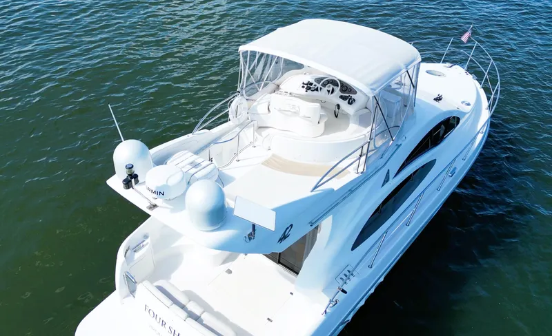 Four Shore Yacht Photos Pics Azimut 42 yacht, 2002 model, cruising on calm waters, aerial view.